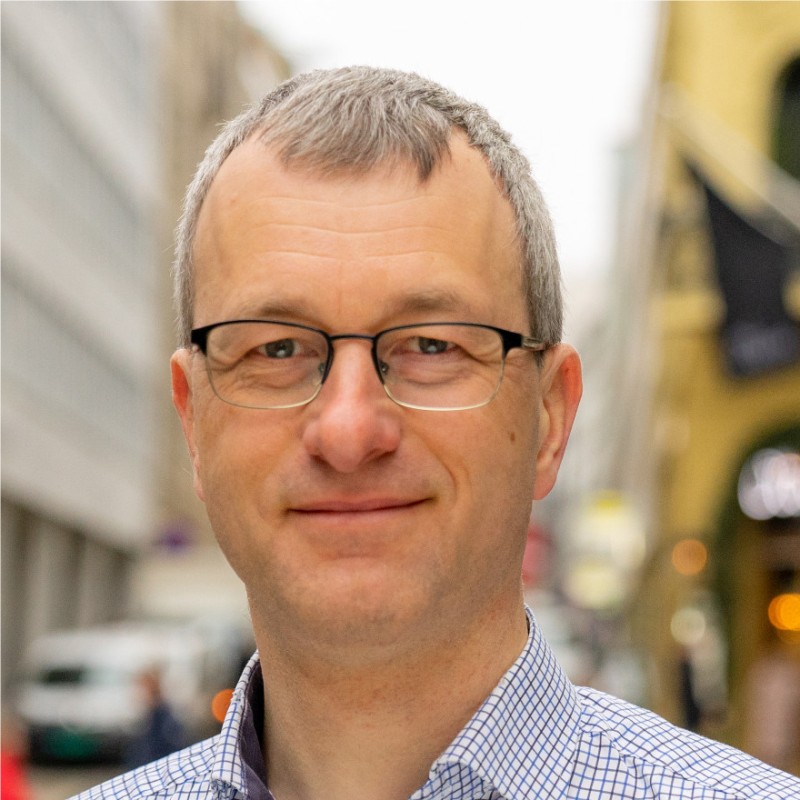 Person in urban setting, blurred background.