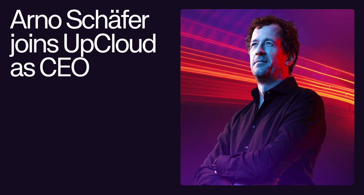 Arno Schäfer, UpCloud's new CEO, stands confidently with arms crossed against a dynamic background.