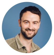 dark haired bearded man, blue background